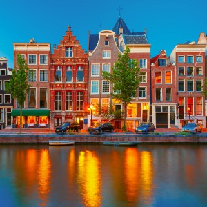 Night city view of Amsterdam canal with dutch houses