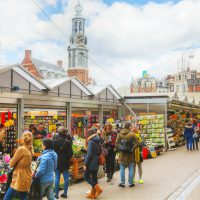 Amsterdam, The Netherlands - April 17, 2015: Floating flower market with people in Amsterdam, Netherlands. It?s usually billed as the ?world?s only floating flower market?.